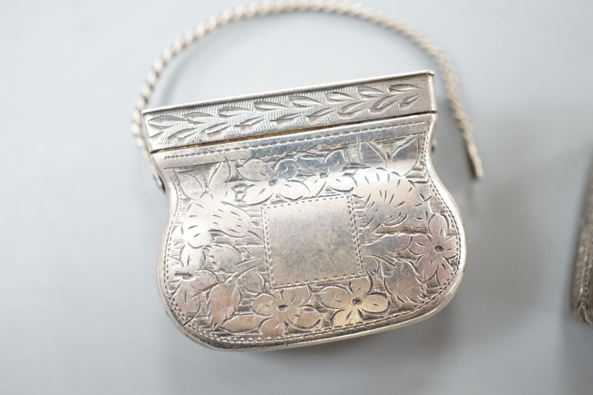 A George IV novelty silver vinaigrette, modelled as a handbag, Gervase Wheeler, Birmingham, 1832, 27mm(handle at one end detached), one other silver vinaigrette, Edward Smith, Birmingham, 1829 and a similar silver 'book'
